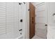 Clean bathroom with white subway tile, soaking tub, and wooden storage at 1501 N Miller Rd # 1010, Scottsdale, AZ 85257