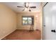 Bright bedroom with ceiling fan, carpet, and window at 15627 W Acapulco Ln, Surprise, AZ 85379