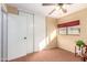 Bedroom with ceiling fan and mirrored closet doors at 15627 W Acapulco Ln, Surprise, AZ 85379