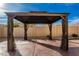 Backyard gazebo with a dark metal frame and curtains at 15627 W Acapulco Ln, Surprise, AZ 85379