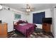 Bedroom with a plush bed, tv, and ceiling fan at 15721 W Lundberg St, Surprise, AZ 85374