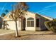 One-story house with a beige exterior, two-car garage, and desert landscaping at 1626 W Kesler Ln, Chandler, AZ 85224