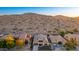 Aerial view of a luxury home with a mountain backdrop at 18133 W Las Cruces Dr, Goodyear, AZ 85338