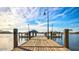 Wooden dock extends over calm lake water, offering scenic views at 18133 W Las Cruces Dr, Goodyear, AZ 85338