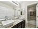 Modern bathroom with double sinks, granite countertop, and a shower/tub combo at 18407 W Fulton St, Goodyear, AZ 85338