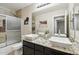 Modern bathroom with double sinks, granite countertop, and a walk-in shower at 18407 W Fulton St, Goodyear, AZ 85338