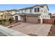 Two story house with a three car garage and brick driveway at 18407 W Fulton St, Goodyear, AZ 85338