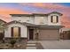 Two-story house with stone accents and a three-car garage at 18407 W Fulton St, Goodyear, AZ 85338