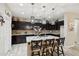 Modern kitchen with granite countertops, dark cabinets, and an island at 18407 W Fulton St, Goodyear, AZ 85338