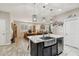 Kitchen features a large island with sink, dark cabinetry, and tile flooring at 18407 W Fulton St, Goodyear, AZ 85338