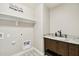 Convenient laundry room with built-in cabinets and shelving at 18407 W Fulton St, Goodyear, AZ 85338