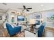 Cozy living room featuring a built-in entertainment center and comfortable blue sofas at 18407 W Fulton St, Goodyear, AZ 85338