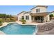 Inviting backyard oasis with a large pool, waterfall feature, and patio seating at 18407 W Fulton St, Goodyear, AZ 85338