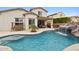 Inviting backyard pool with a waterfall feature and patio at 18407 W Fulton St, Goodyear, AZ 85338