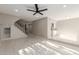 Bright living room with tile floors, staircase, and built-in shelving at 1927 E Duke Dr, Tempe, AZ 85283