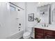 Bathroom with tub, shower, and dark brown vanity at 2203 N 166Th Dr, Goodyear, AZ 85395