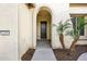 Arched entryway with dark brown door and drought-tolerant landscaping at 2203 N 166Th Dr, Goodyear, AZ 85395