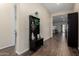 Home entry hall with dark wood floor and coat rack at 24102 N 164Th Dr, Surprise, AZ 85387