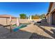 Inviting rectangular pool with surrounding patio and umbrellas at 24102 N 164Th Dr, Surprise, AZ 85387