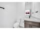 Clean bathroom with dark brown vanity, white countertop and toilet at 2620 W Wolftrap Rd, New River, AZ 85087