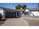 Gray double-car garage with a long driveway at 3308 W Surrey Ave, Phoenix, AZ 85029