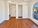 Bright bedroom with wood-look floors and large window at 5221 W Sandra Ter, Glendale, AZ 85306