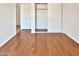 Bedroom with hardwood floors and mirrored closet doors at 5221 W Sandra Ter, Glendale, AZ 85306