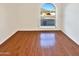 Bedroom with hardwood floors and an arched window at 5221 W Sandra Ter, Glendale, AZ 85306