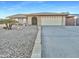 Single story home with two-car garage and desert landscaping at 5221 W Sandra Ter, Glendale, AZ 85306