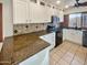 Kitchen with granite countertops, white cabinets, and modern appliances at 5221 W Sandra Ter, Glendale, AZ 85306
