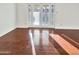 Sunlit living room with hardwood floors and patio access at 5221 W Sandra Ter, Glendale, AZ 85306