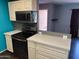 Modern kitchen with stainless steel appliances and white cabinets at 6607 S Mitchell Dr, Tempe, AZ 85283