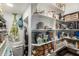 Well-organized pantry with ample shelving for storage at 6746 W Tonto Dr, Glendale, AZ 85308