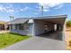 Mobile home with carport and artificial turf at 6828 W Pierce St # 126, Phoenix, AZ 85043