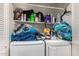 Laundry room with washer, dryer, and storage shelves at 6828 W Pierce St # 126, Phoenix, AZ 85043