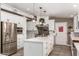 Bright kitchen with white cabinets, stainless steel appliances, and an island at 705 W Harwell Rd, Phoenix, AZ 85041