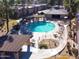 Aerial view of a community pool with surrounding lounge chairs and landscaping at 7436 E Chaparral Rd # B213, Scottsdale, AZ 85250