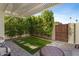 Private backyard oasis with artificial turf, pergola, and seating area at 7925 E Keim Dr, Scottsdale, AZ 85250