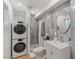 Updated bathroom with shower, toilet, and stacked washer/dryer at 7925 E Keim Dr, Scottsdale, AZ 85250