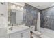 Spa-like bathroom with marble-look tile, a large mirror and a white vanity at 7925 E Keim Dr, Scottsdale, AZ 85250