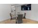 Small dining area with glass table and four chairs, near a bathroom at 7925 E Keim Dr, Scottsdale, AZ 85250