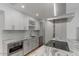 Modern kitchen with white cabinets, granite counters, and stainless steel appliances at 7925 E Keim Dr, Scottsdale, AZ 85250