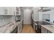 Modern kitchen with white cabinets, granite countertops and stainless steel appliances at 7925 E Keim Dr, Scottsdale, AZ 85250