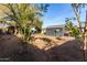 Spacious backyard, featuring a detached garage and landscaping at 905 E Weldon Ave, Phoenix, AZ 85014