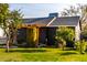 House with a dark exterior, wooden pergola, and green lawn at 905 E Weldon Ave, Phoenix, AZ 85014