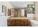 Elegant bathroom with double vanity, soaking tub, and decorative artwork at 9137 N 116Th Pl, Scottsdale, AZ 85259