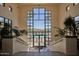 Community center interior view showcasing a grand staircase and resort-style pool view at 9137 N 116Th Pl, Scottsdale, AZ 85259