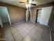 Bedroom with tiled floors, ceiling fan and adjacent bathroom at 11331 N Langford Ave, Youngtown, AZ 85363