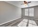 Bright bedroom with wood-look floors and ceiling fan at 1255 N Arizona Ave # 1276, Chandler, AZ 85225
