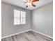 Simple bedroom with wood-look floors and ceiling fan at 1255 N Arizona Ave # 1276, Chandler, AZ 85225